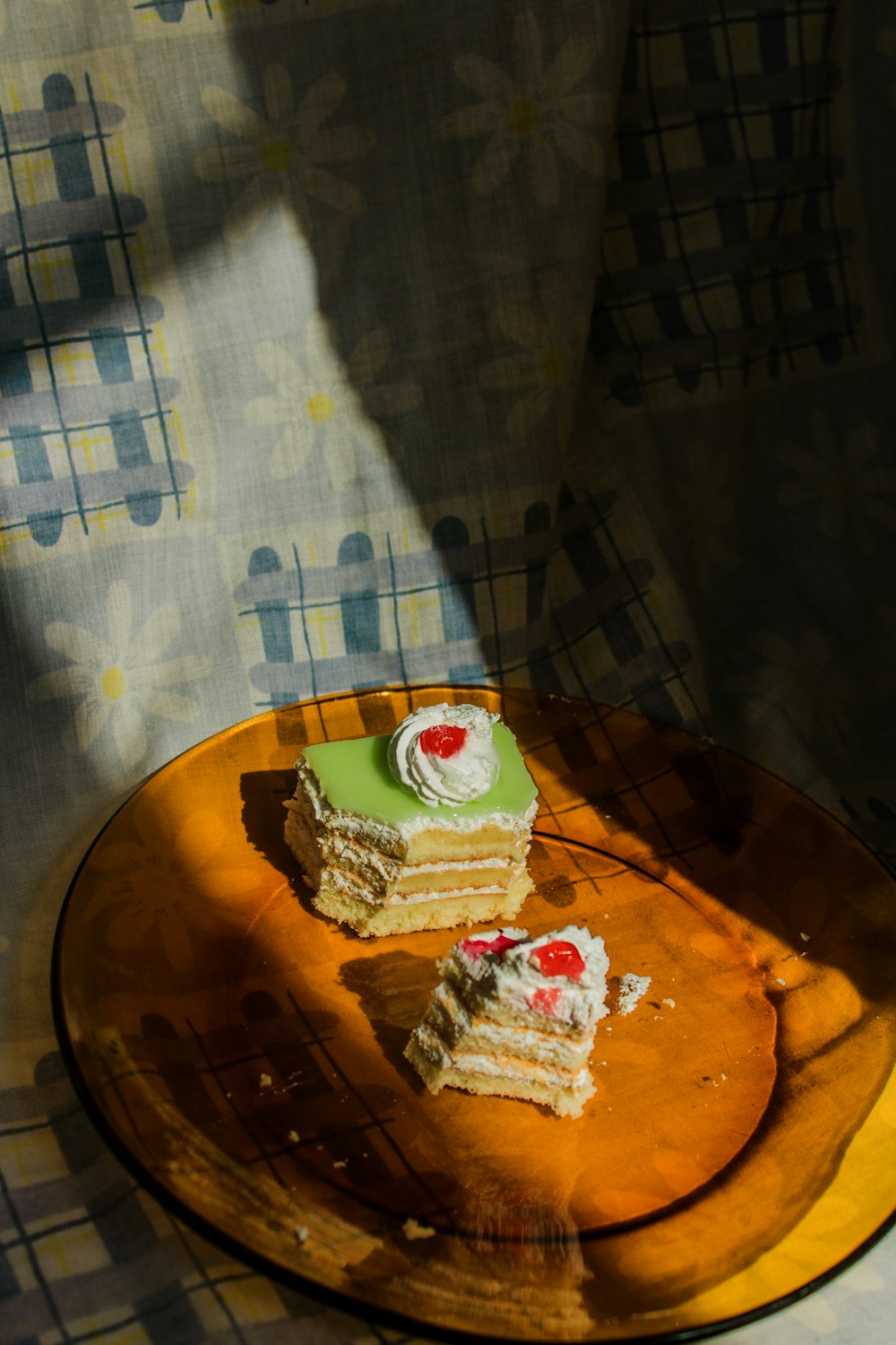 sliced cake on amber glass plate