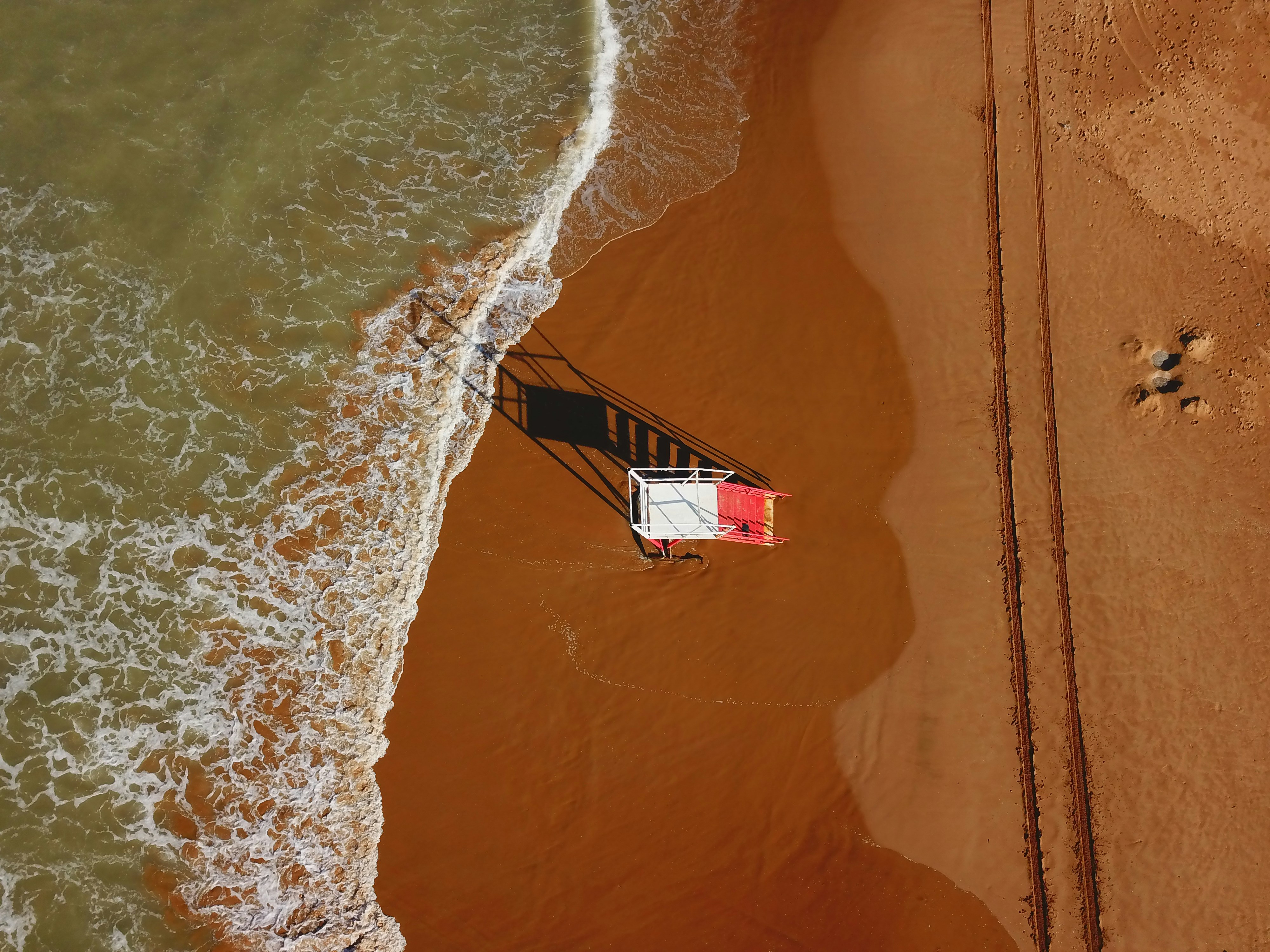 Fotografía aérea de la torre de vigilancia de salvavidas en la playa durante el día