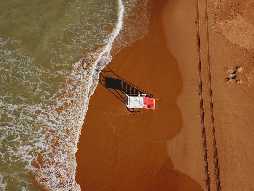 aerial photography of lifeguard watchtower on beach during daytime