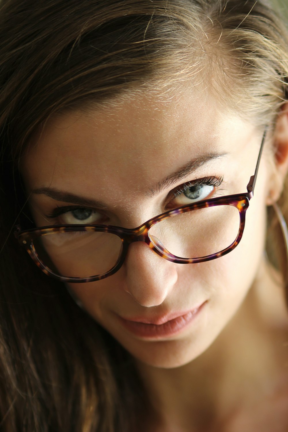 woman wearing brown-framed eyeglasses