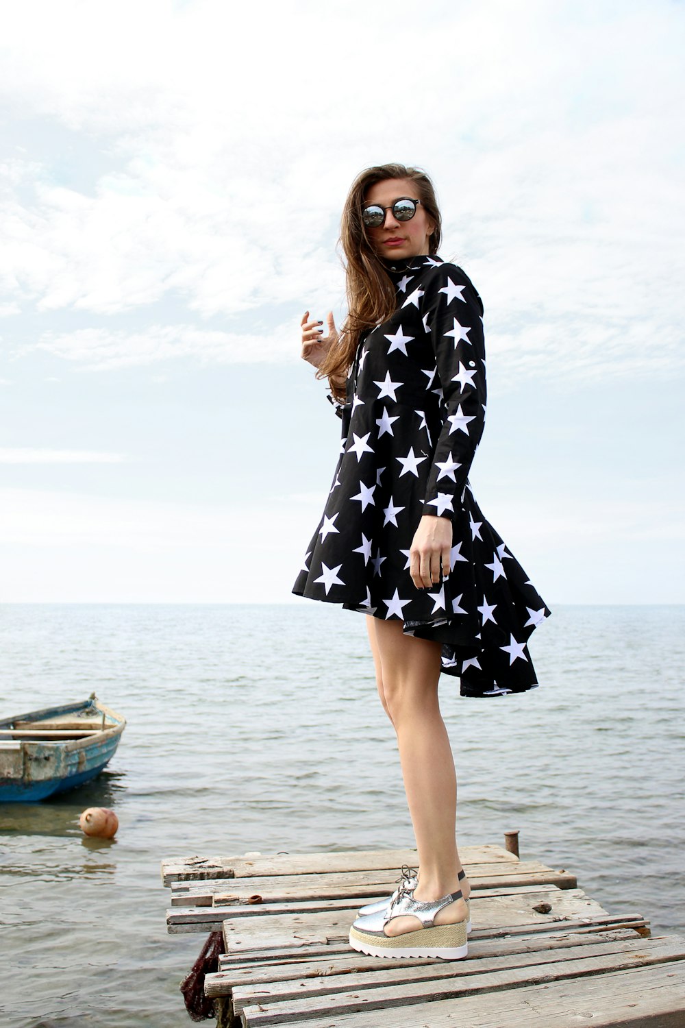 woman wearing white and black star print dress