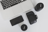 A stylish flat lay of influencer tools: camera, laptop, and notes on a minimalist desk.