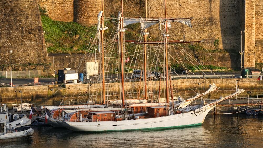 white boat docked near beige wall