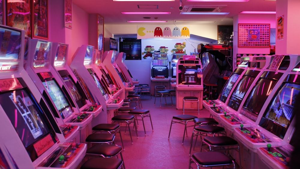 turned-on arcade machines with stools