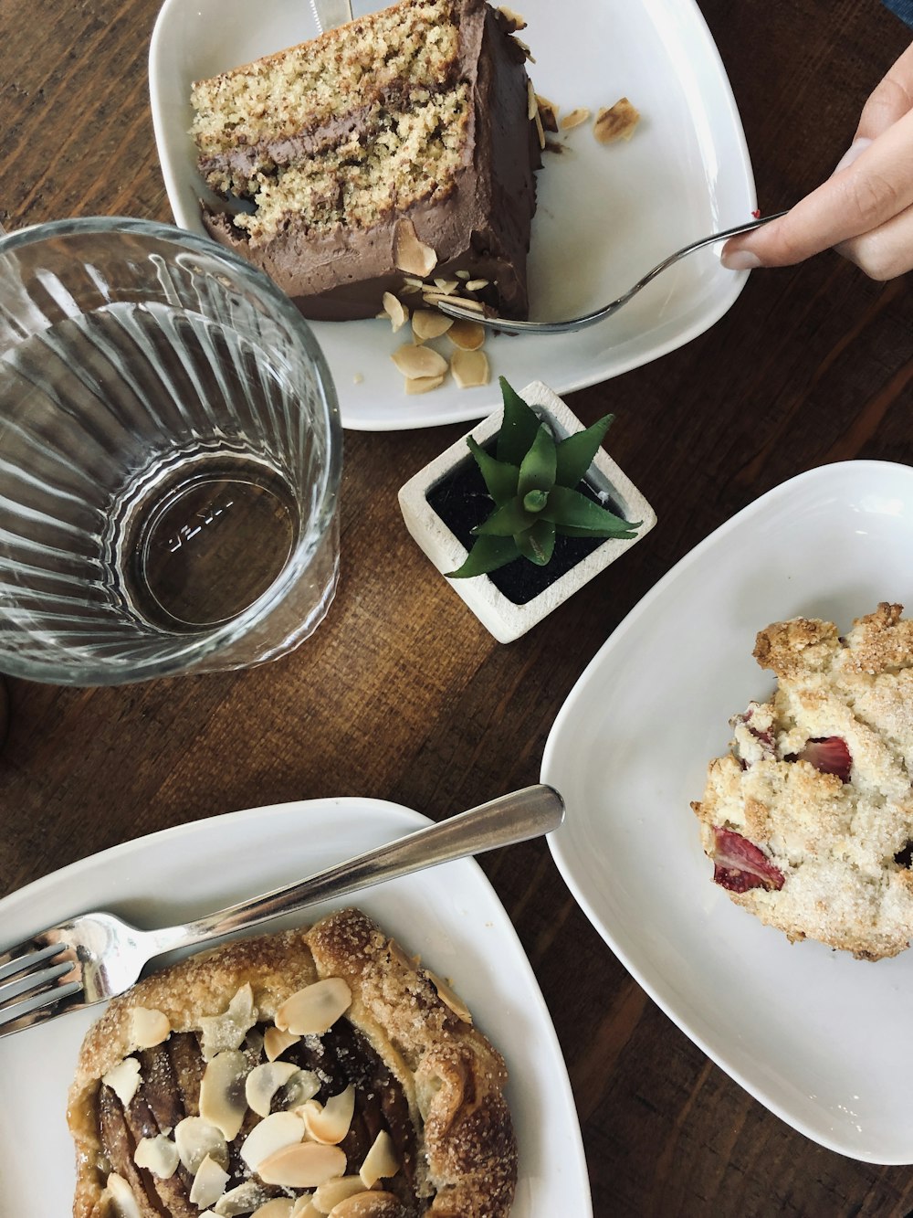 chocolate cake beside succulent and drinking glass