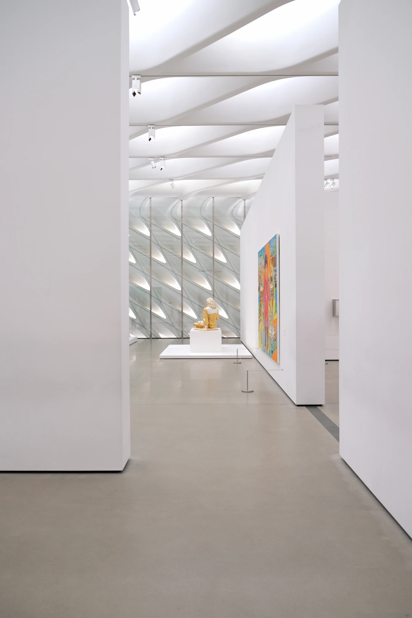 A statue in an empty, well-lit museum
