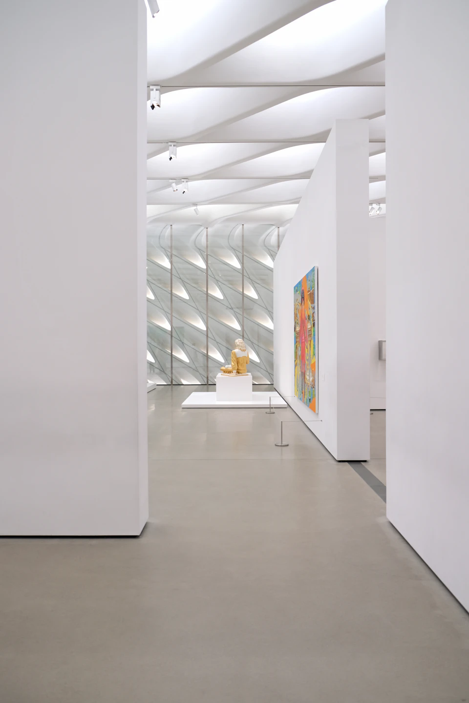 A statue in an empty, well-lit museum