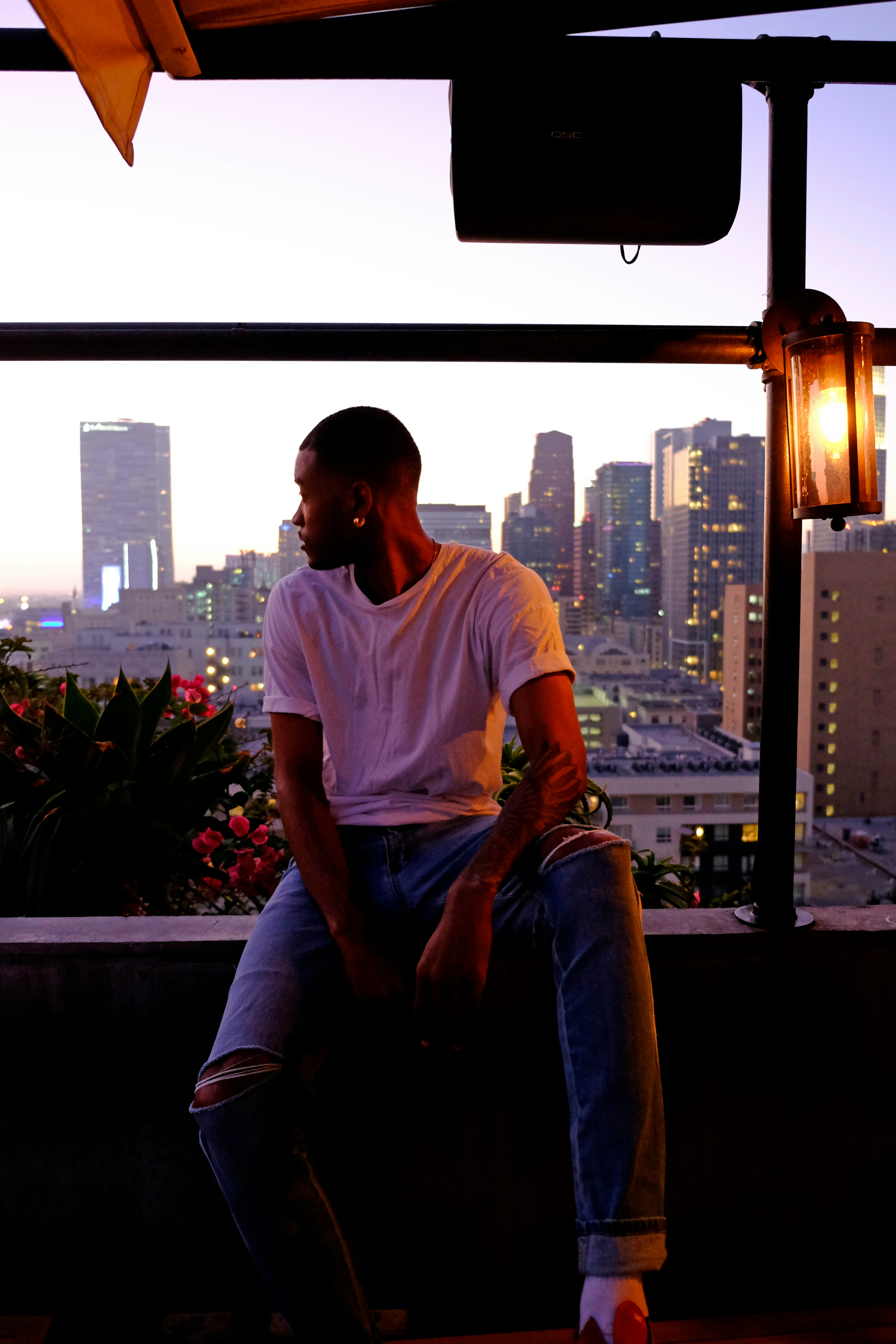 man sitting near flowers