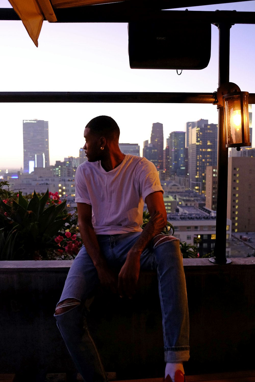 man sitting near flowers