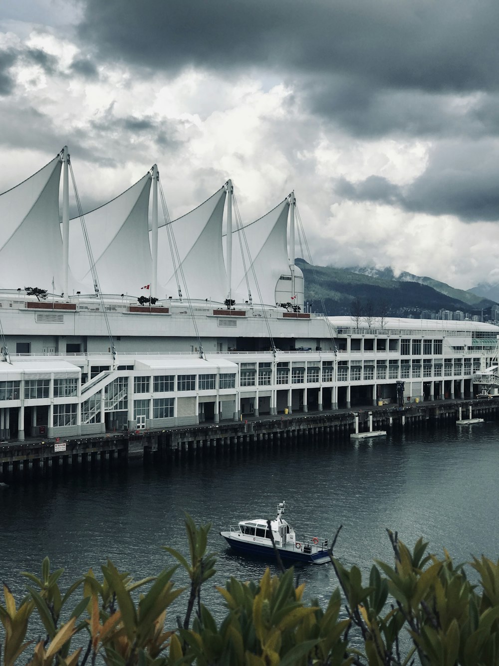 boat in front of building under cloudy sky