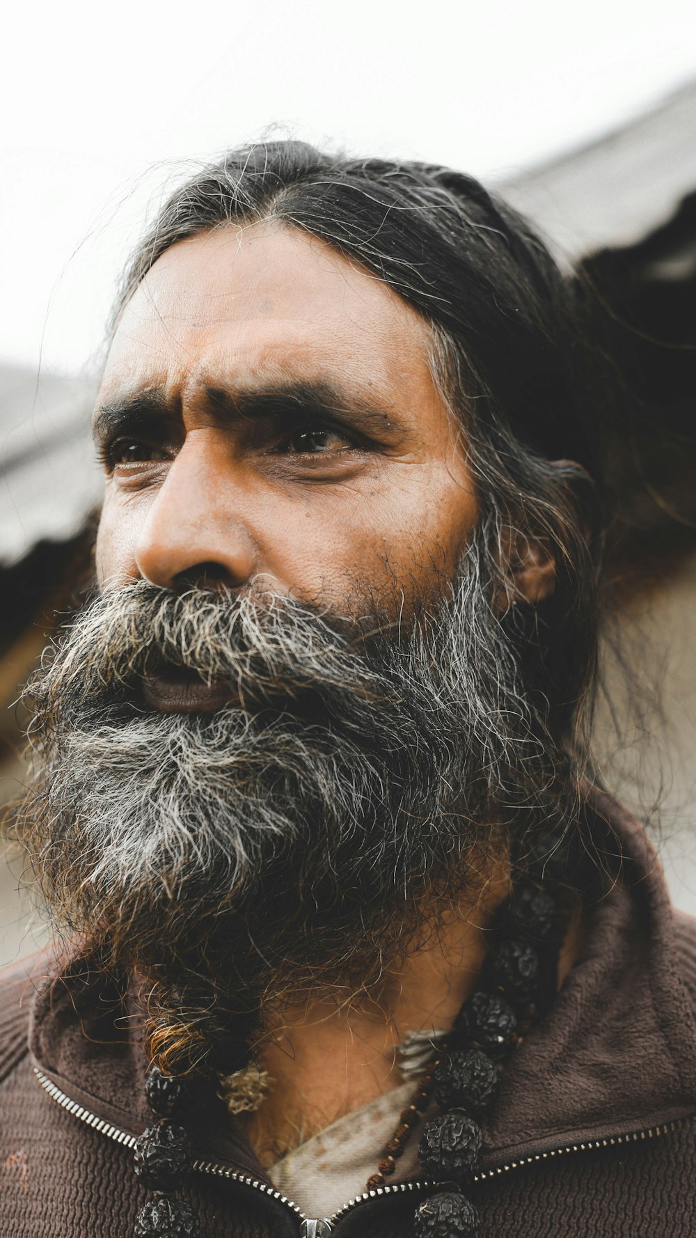 focus photography of man in brown collared top