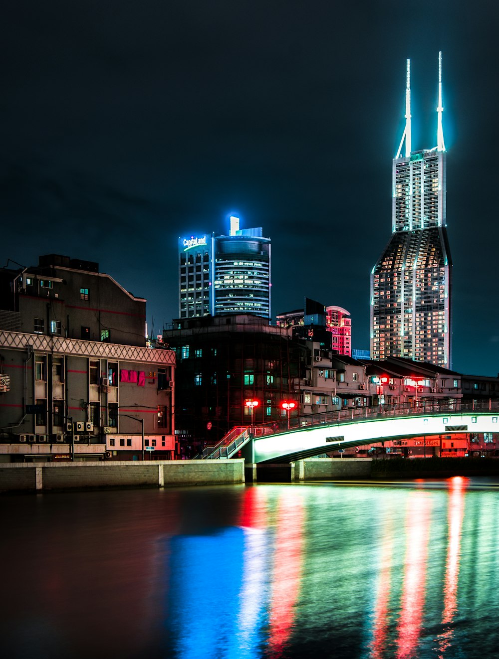 high-rise lighted buildings near body of water