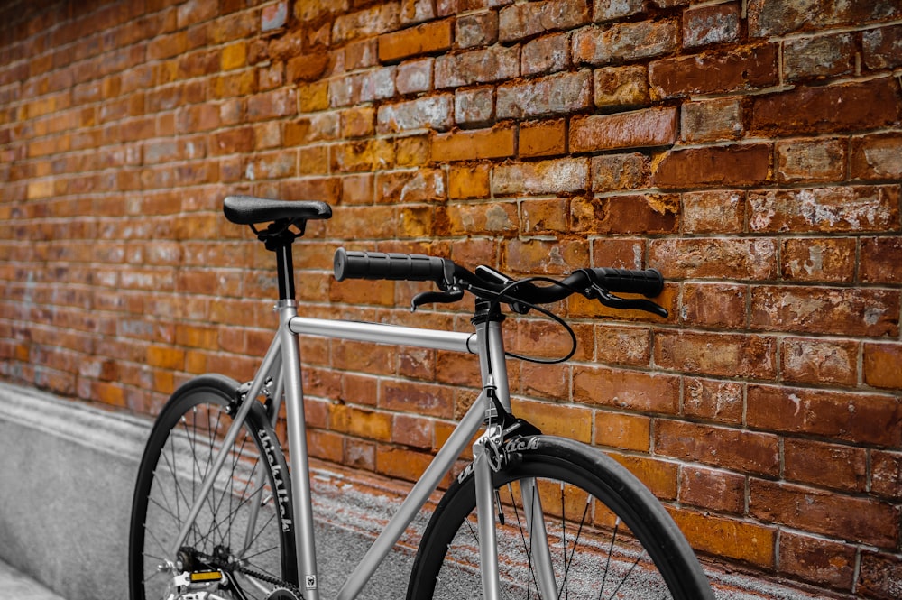 gray bike leaned on wall