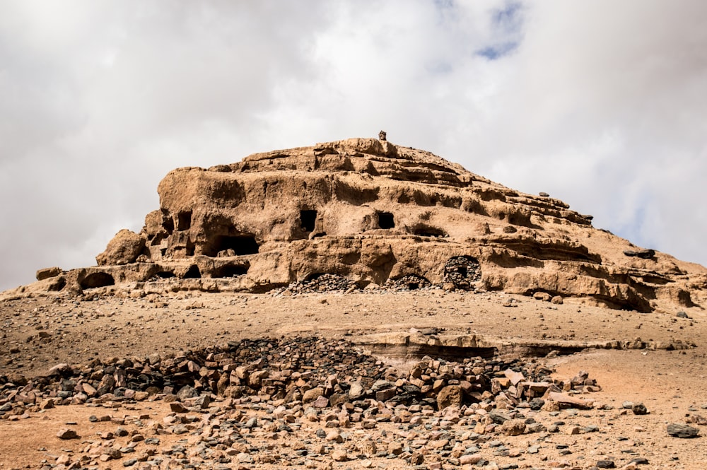 brown rock formation against white sky