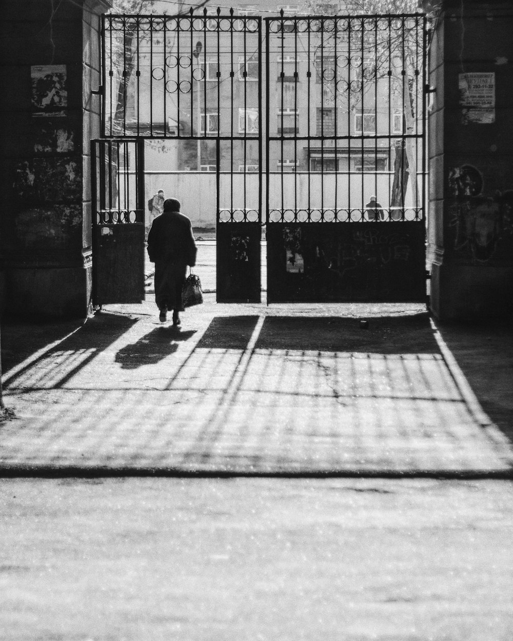 woman walking beside gate
