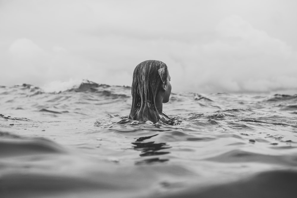 grayscale photography of woman in water during daytime