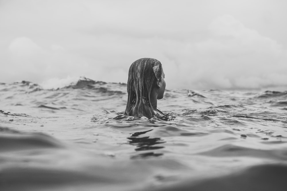 grayscale photography of woman in water during daytime