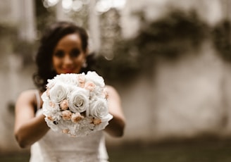 woman holding bouquet of flower