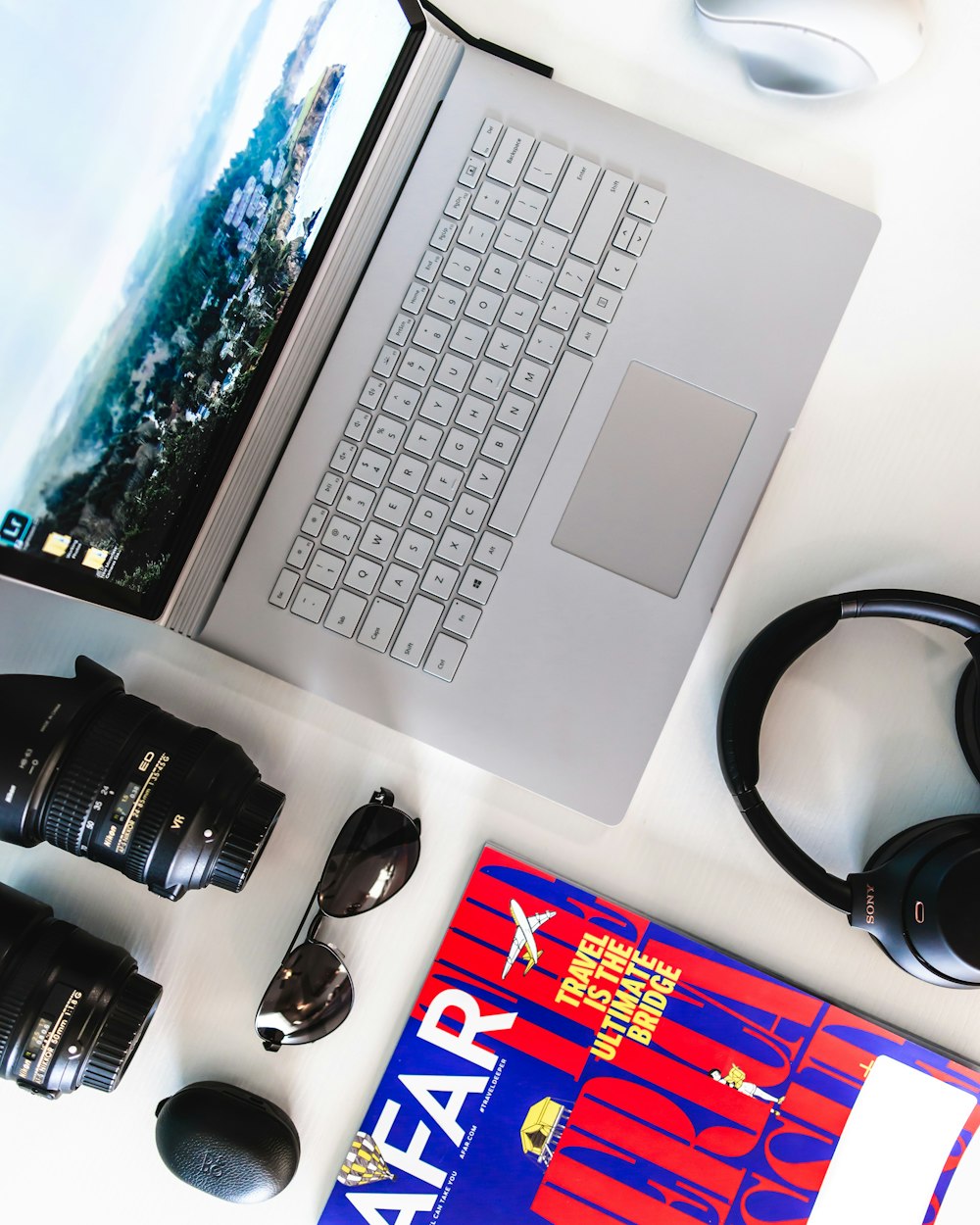 flat lay photography of gray laptop computer and headphones