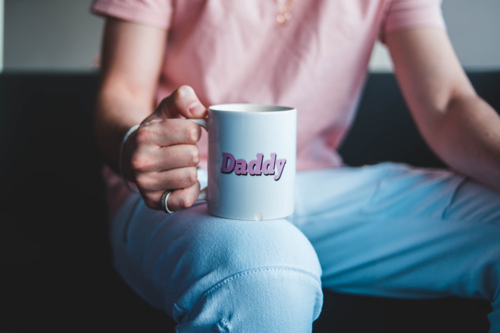 person holding white ceramic mug