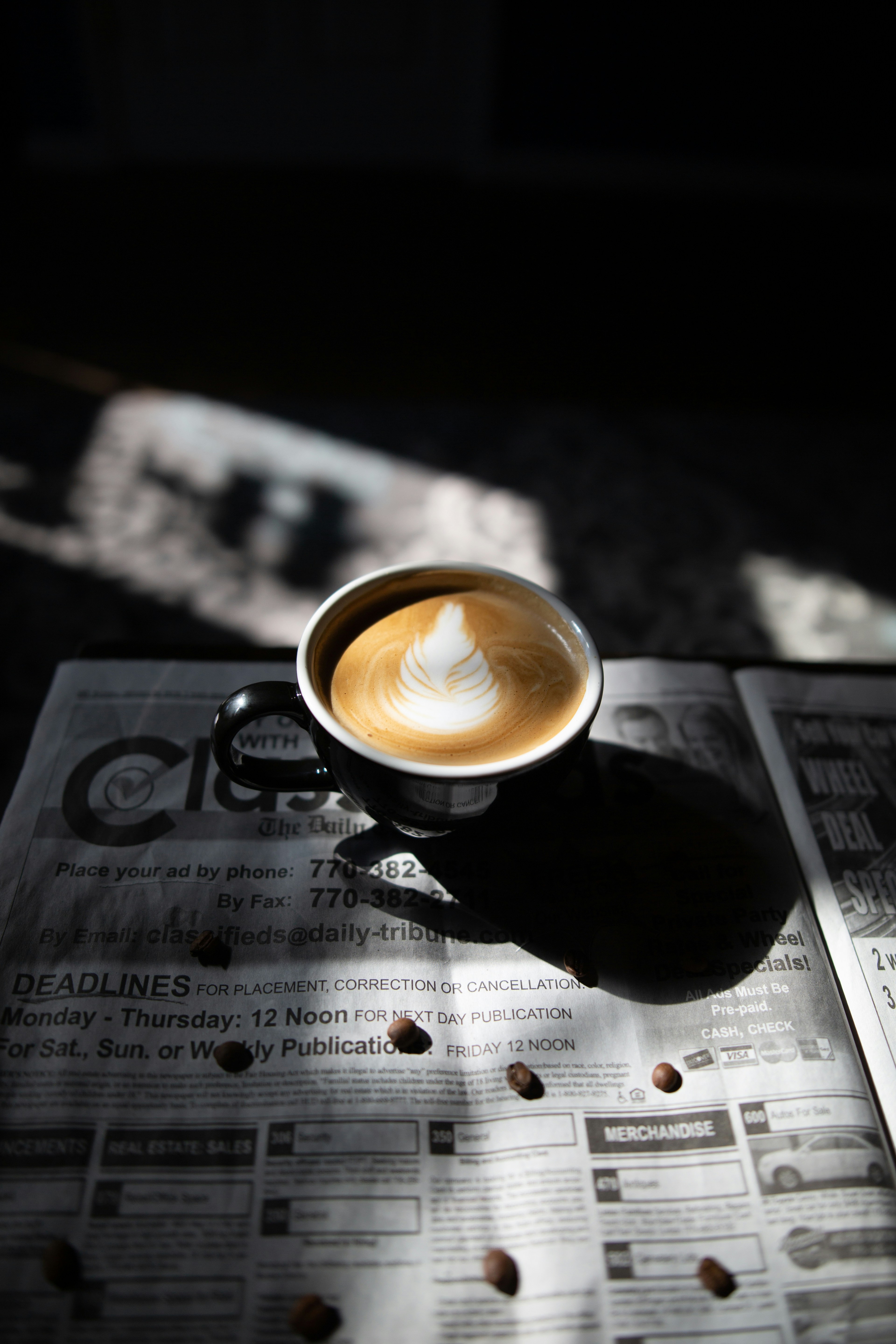 selective focus photography of latte art in black ceramic cup