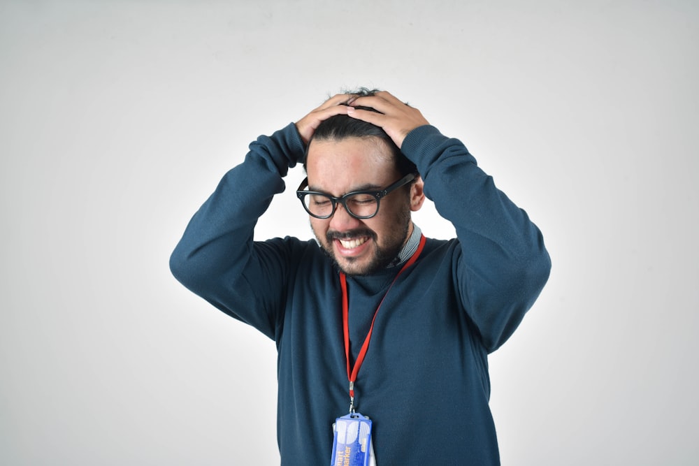 angry man in blue sweater by Ahmad Gunnaivi