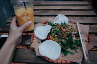 clear disposable cup on left human hnad