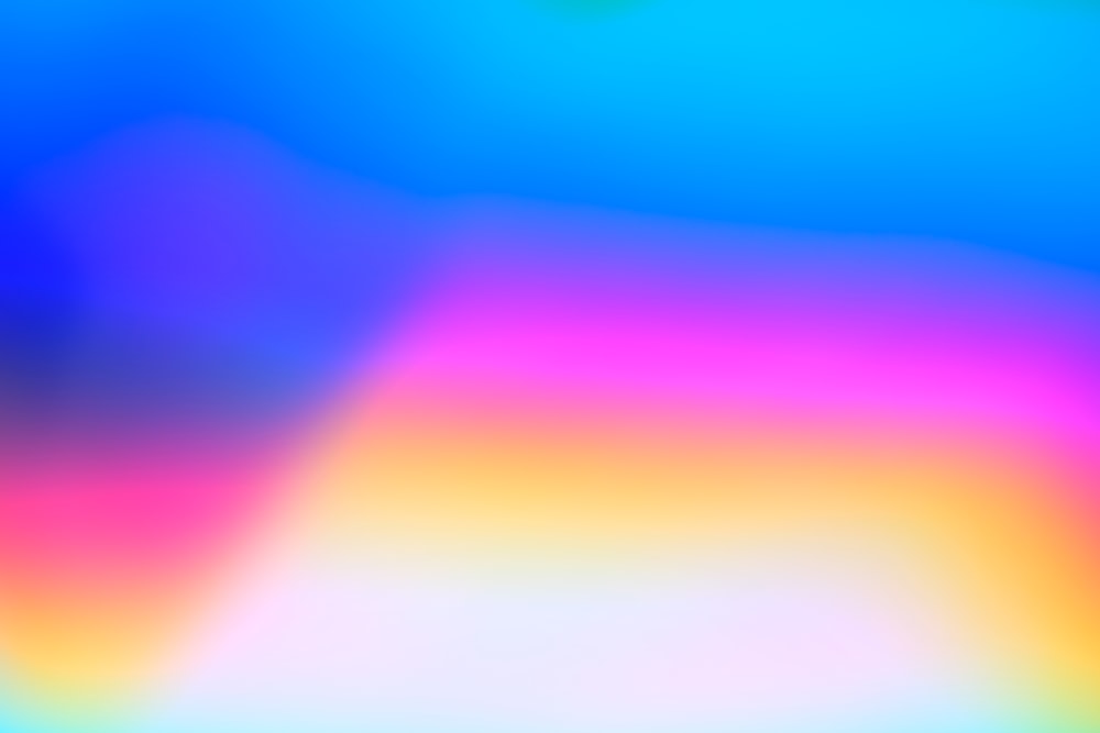 a blurry image of a rainbow colored background