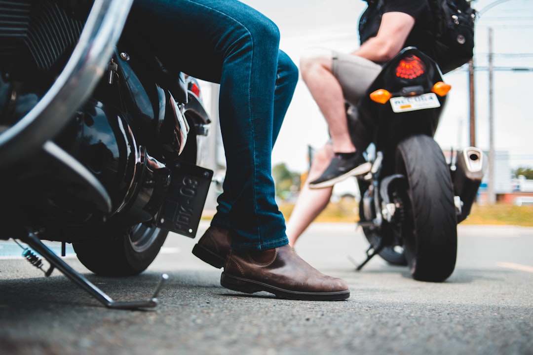 person on motorcycles on paved road