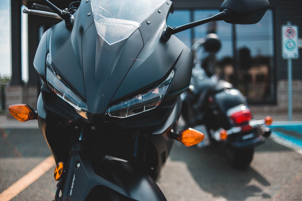 black motorcycle parked near another motorcycle