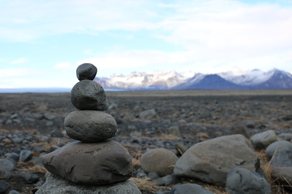 close-up of gray stone balance near mountain