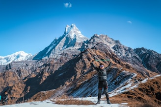man standing by the rock formation