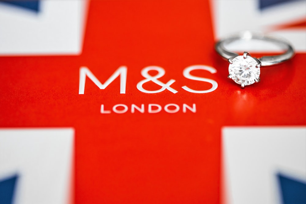 silver-colored clear gemstone round-cut ring on M&S London surface