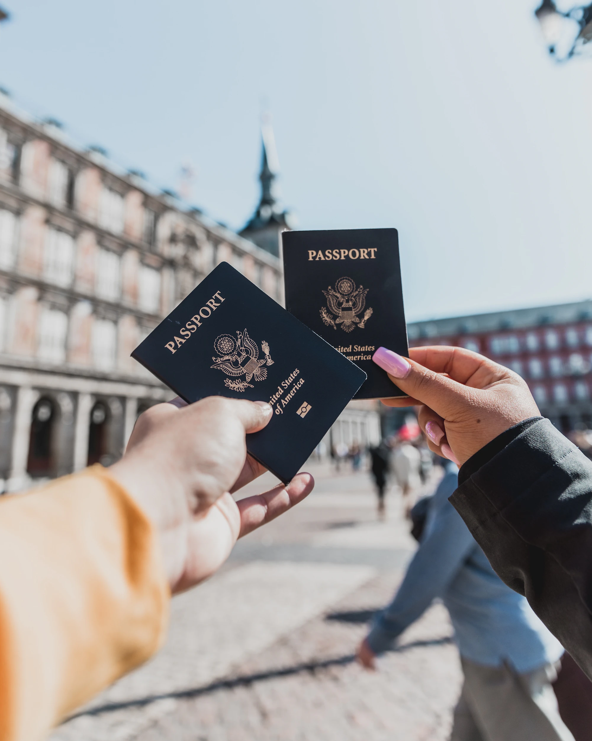 Person holding passports while preparing a residence application