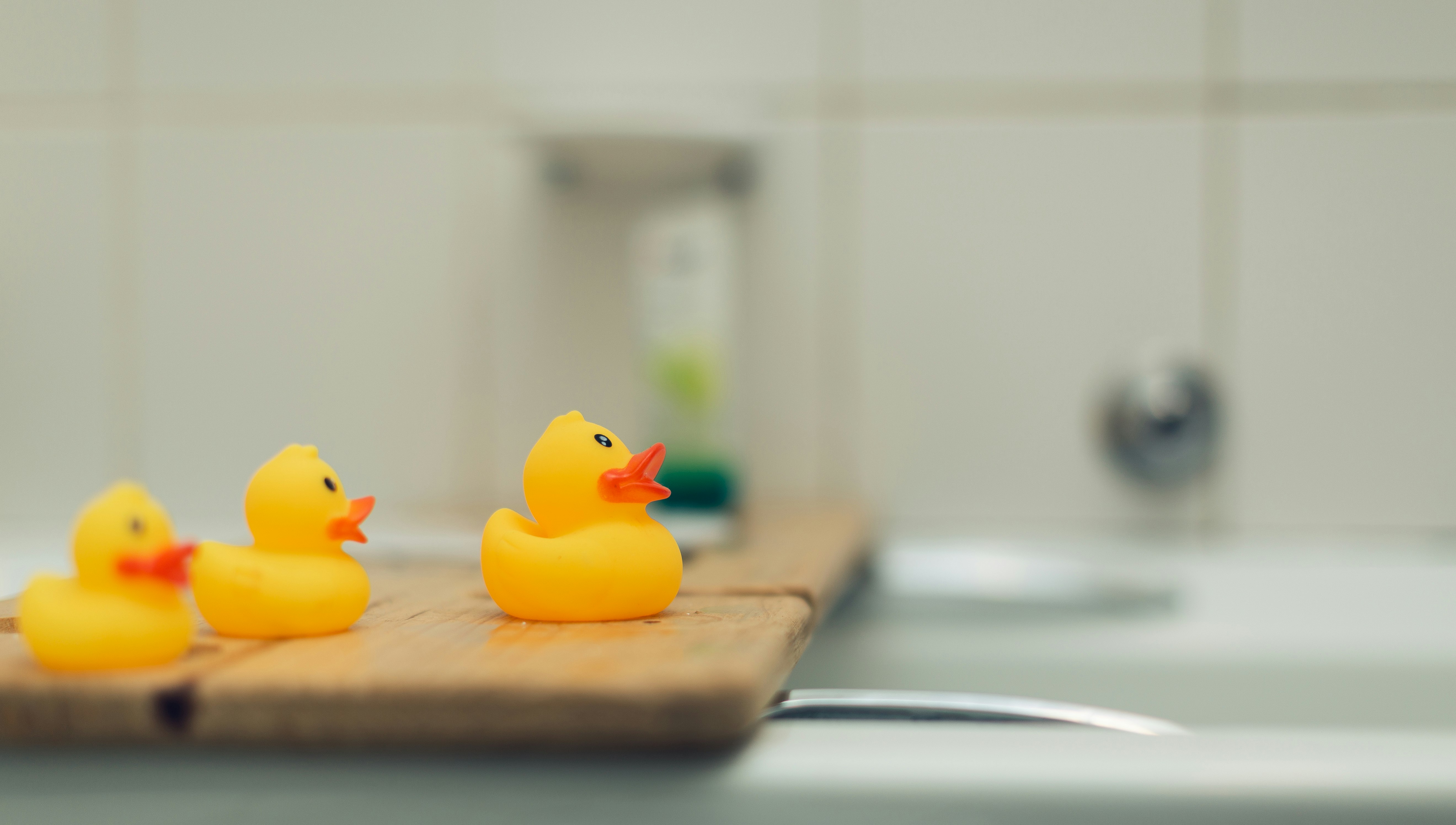 three yellow rubber duckies