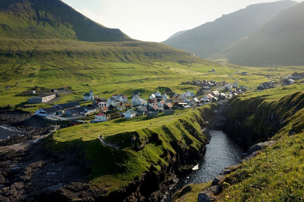 houses near the body of water under blue sky during daytime