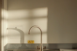 A technician installing a sleek electric water heater in a modern kitchen.
