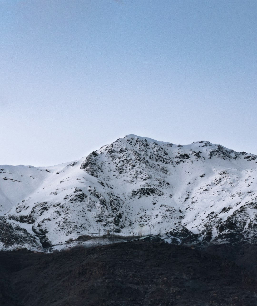 snow covered mountain range during daytime