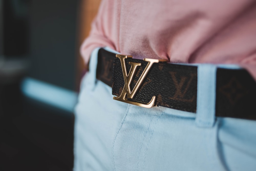 person wearing Louis Vuitton leather belt