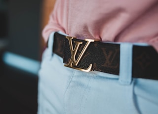 person wearing Louis Vuitton leather belt