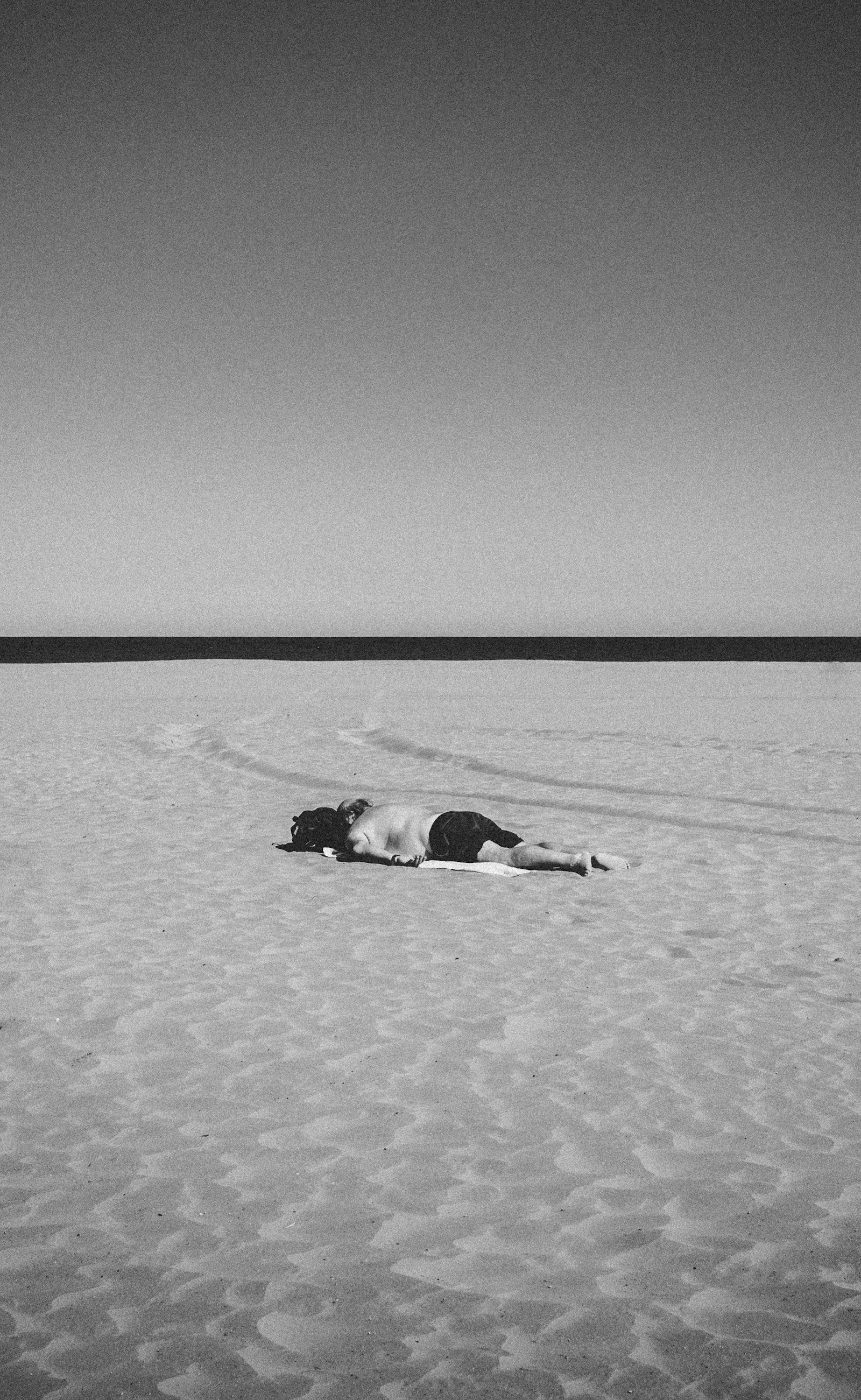 Leica M10-P sample photo. Person lying on sand photography