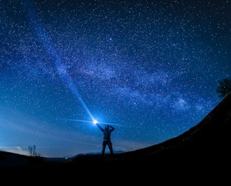 silhouette of man holding flashlight