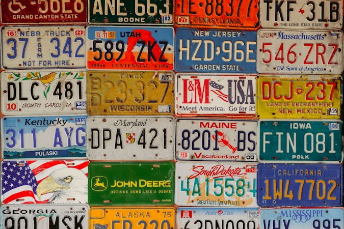 A wall covered in assorted vehicle license plates, representing the plate data collected by automated readers