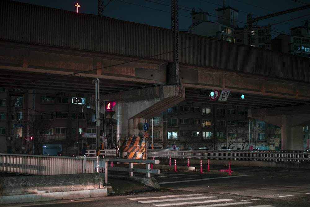 a city street at night with a traffic light