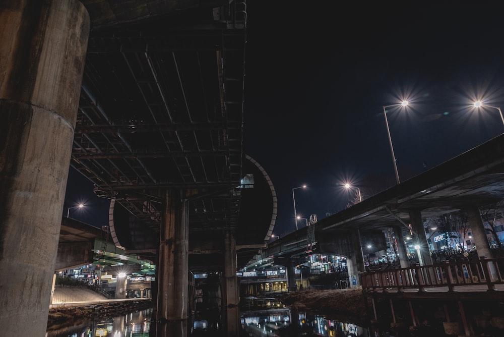 a night scene of a train station with lights on