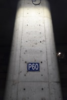 Before and after shots of a reinforced concrete column with repaired surface.