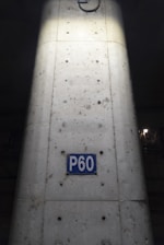 Engineers inspecting a reinforced concrete column with carbon fiber wrapping.