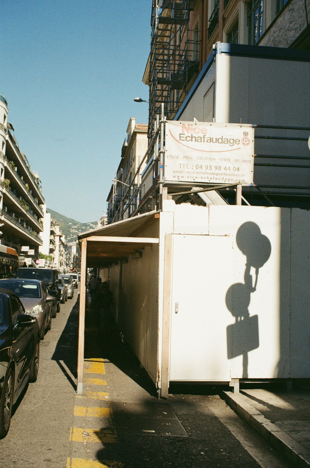 white building beside black vehicle