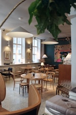 A clean dining area with warm lighting and inviting seating, reflecting a homely atmosphere.