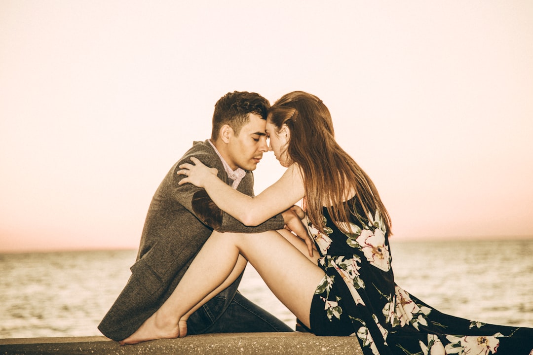 couple sitting beside beach
